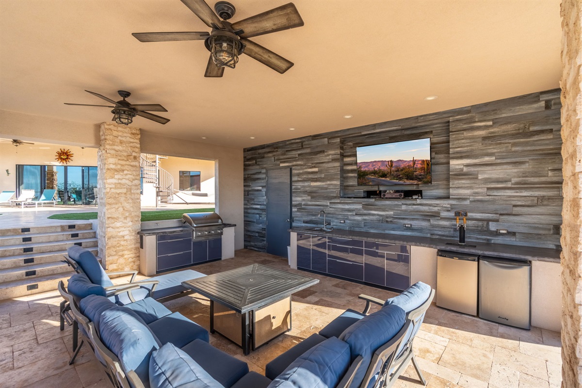 Outdoor entertainment area with TV, shaded seating, and resort-style backyard experience guests love year-round