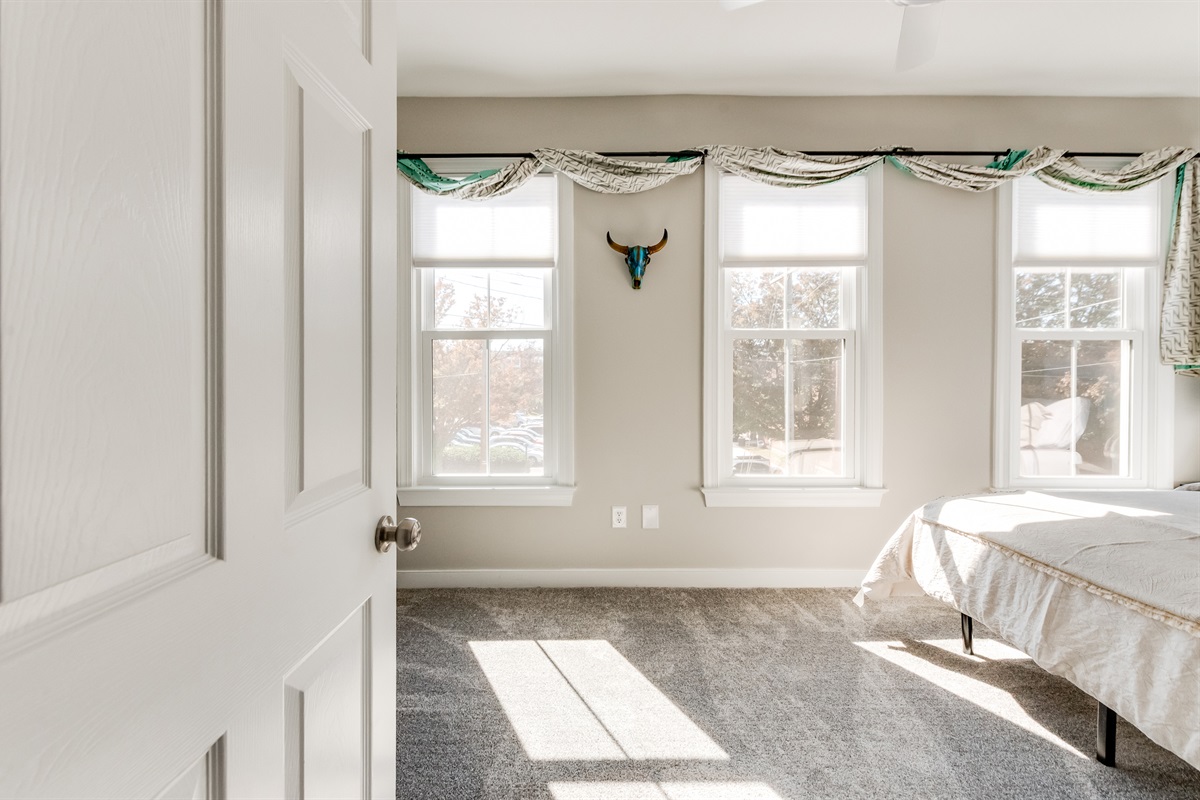 Queen Bedroom 2: Sun-drenched room with chic decor and picturesque views awaits your stay!
