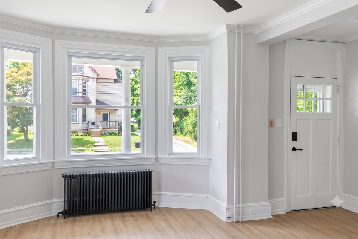 Bay windows and ceiling fans offer plenty of light and circulation throughout the entire space.