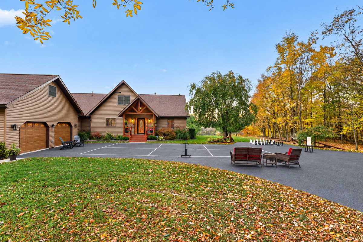 Front driveway with tennis court and autumn foliage
