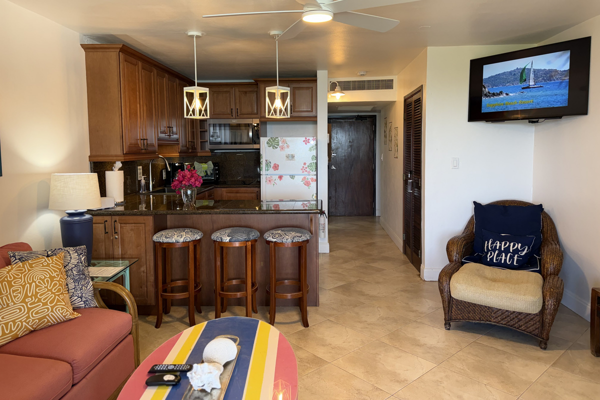 Living room with TV opens to kitchen