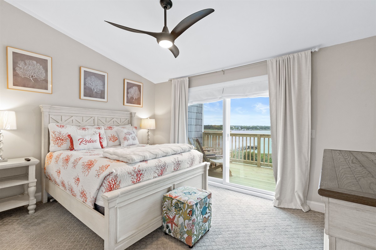 Queen master bedroom with private balcony and stunning water views