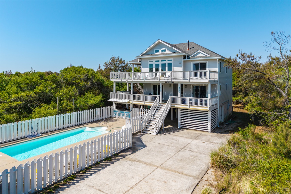 Beautiful exterior view of the home featuring a private pool and driveway parking for 5–6 vehicles. Please note RVs and trailers are not permitted.