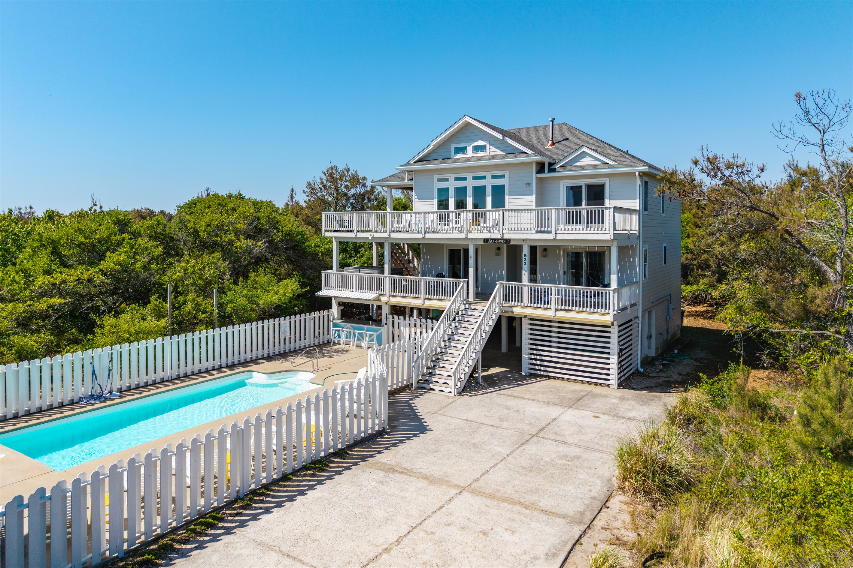 Beautiful exterior view of the home featuring a private pool and driveway parking for 5–6 vehicles. Please note RVs and trailers are not permitted.