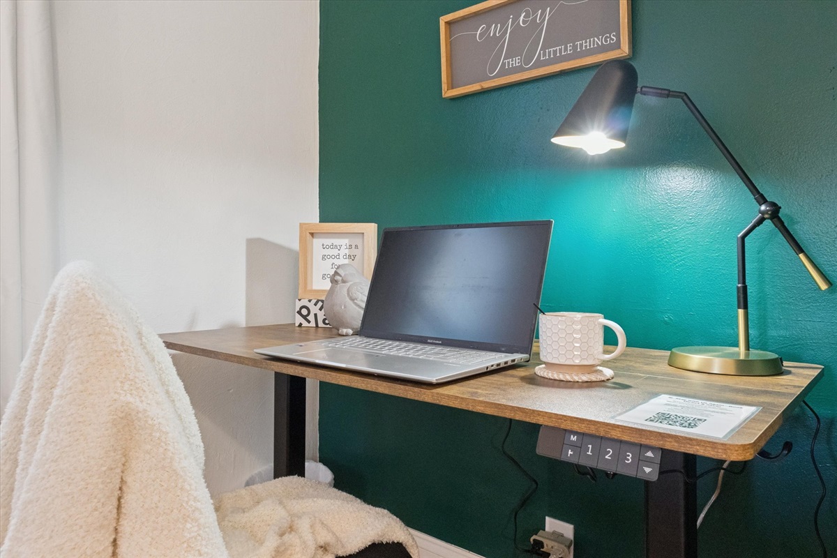 Power up your productivity in our South Bend guest retreat—featuring an electric standing desk with built-in outlets, charging ports, and a comfy chair. Perfect for remote work near Notre Dame