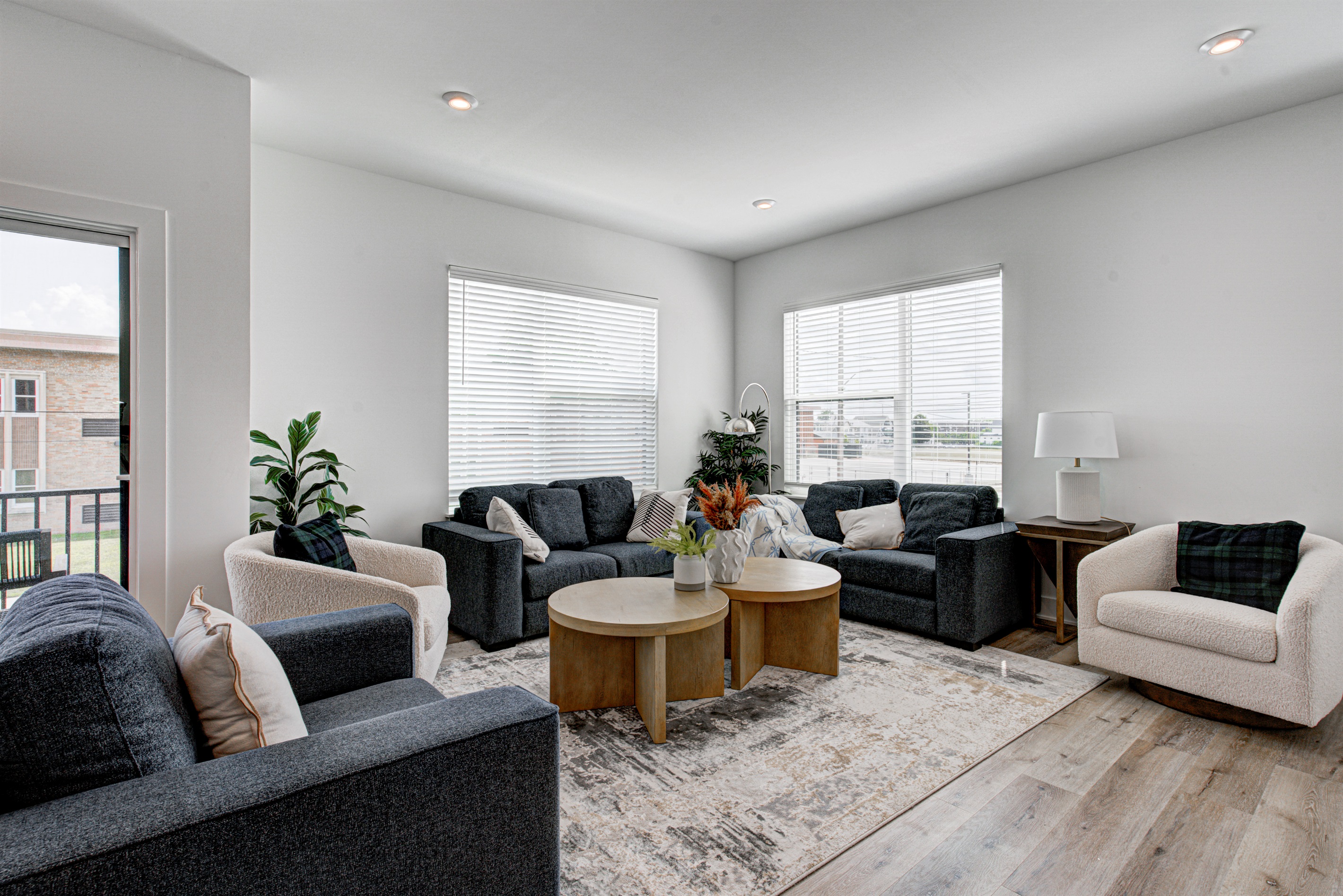 Enjoy a designed open-concept space with a modern kitchen equipped with quartz countertops, stainless steel appliances, and all essentials for home cooking. 