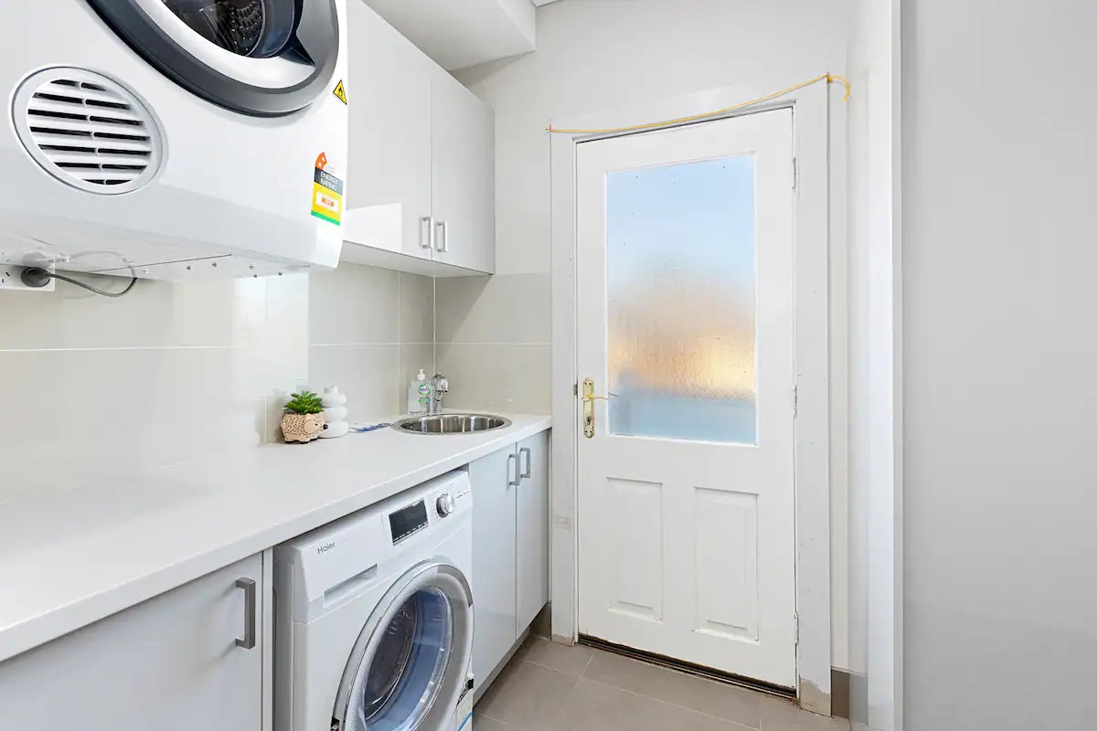 The laundry at Sasha’s Cottage on the Hill includes a washer and dryer, supporting practical stays beyond a quick weekend.