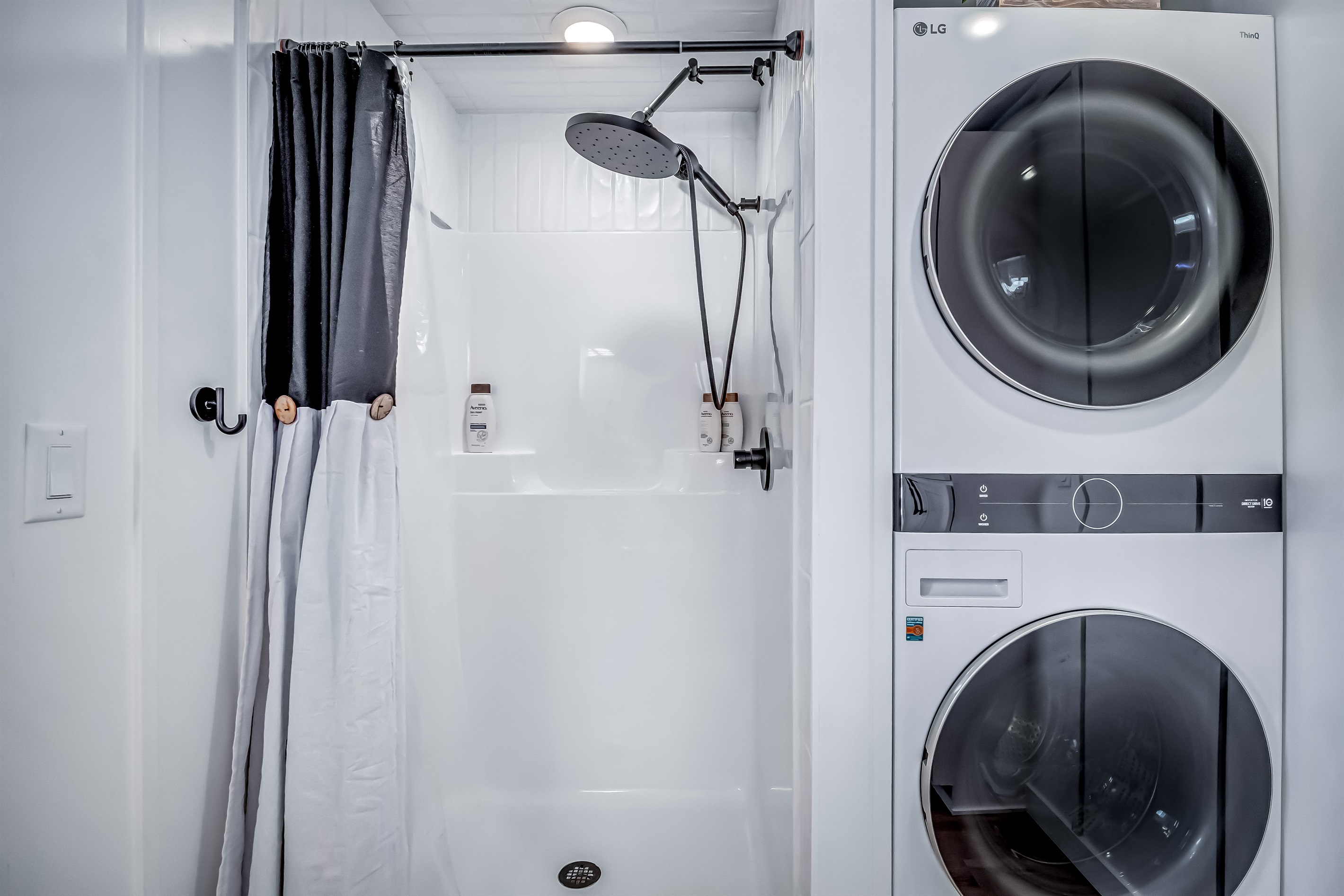 Full bathroom with washer dryer combo unit