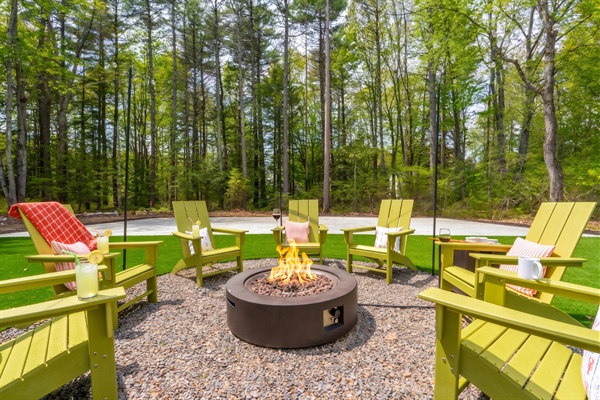 An inviting outdoor firepit surrounded by seating, creating the perfect spot to gather, enjoy drinks, and share stories as the evening winds down.