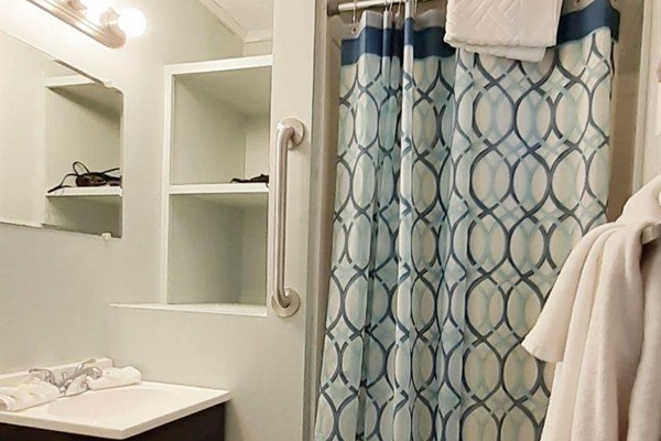 Bathroom has a stand-up shower and is fully stocked with towels and complimentary soap and shampoo for your stay