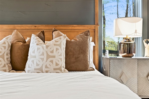 Slumber in style with the comfort of a bed nestled in a room that whispers calm with its modern, earthy tones.