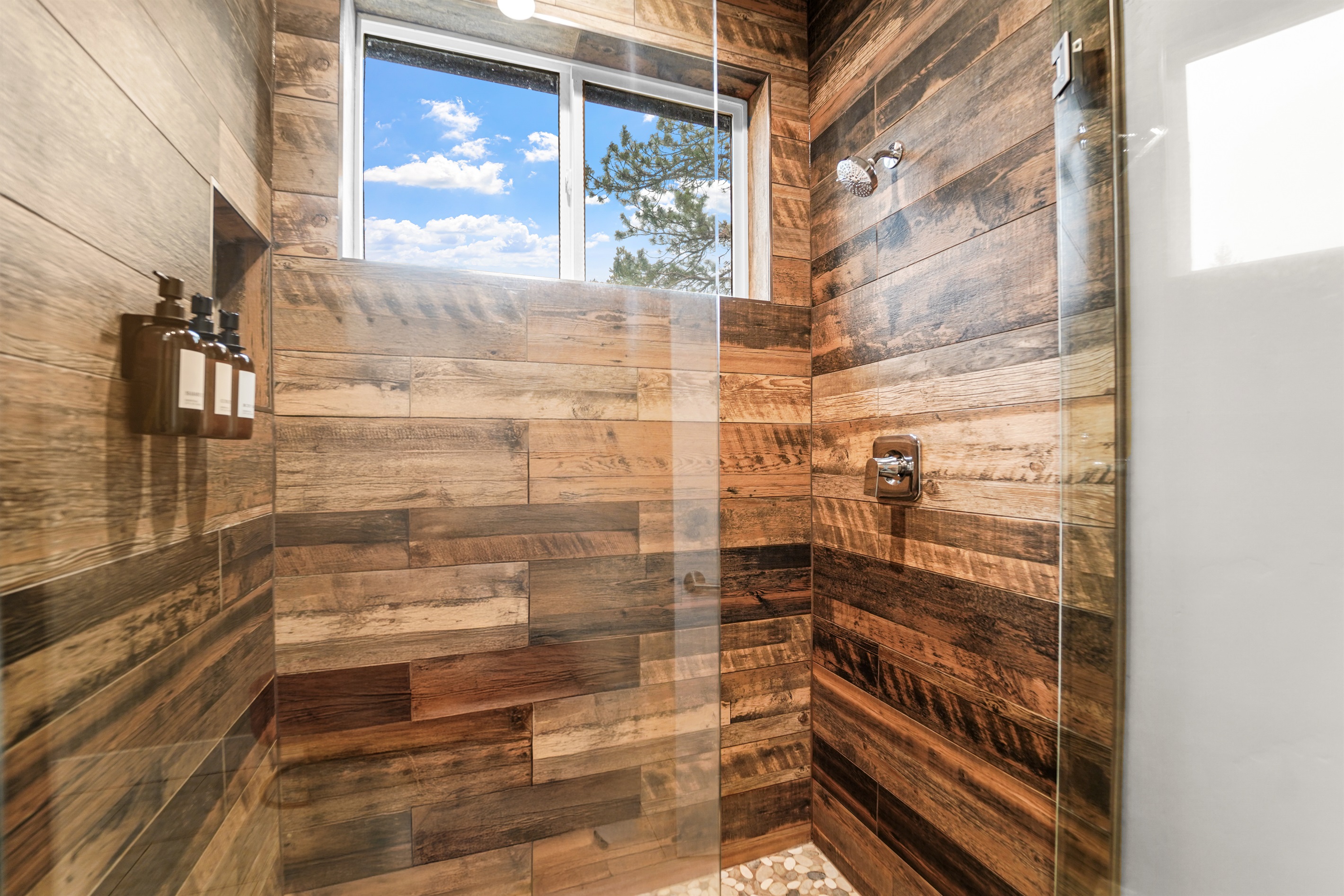 Experience the amazing rustic-modern design of the spacious shower enclosure.