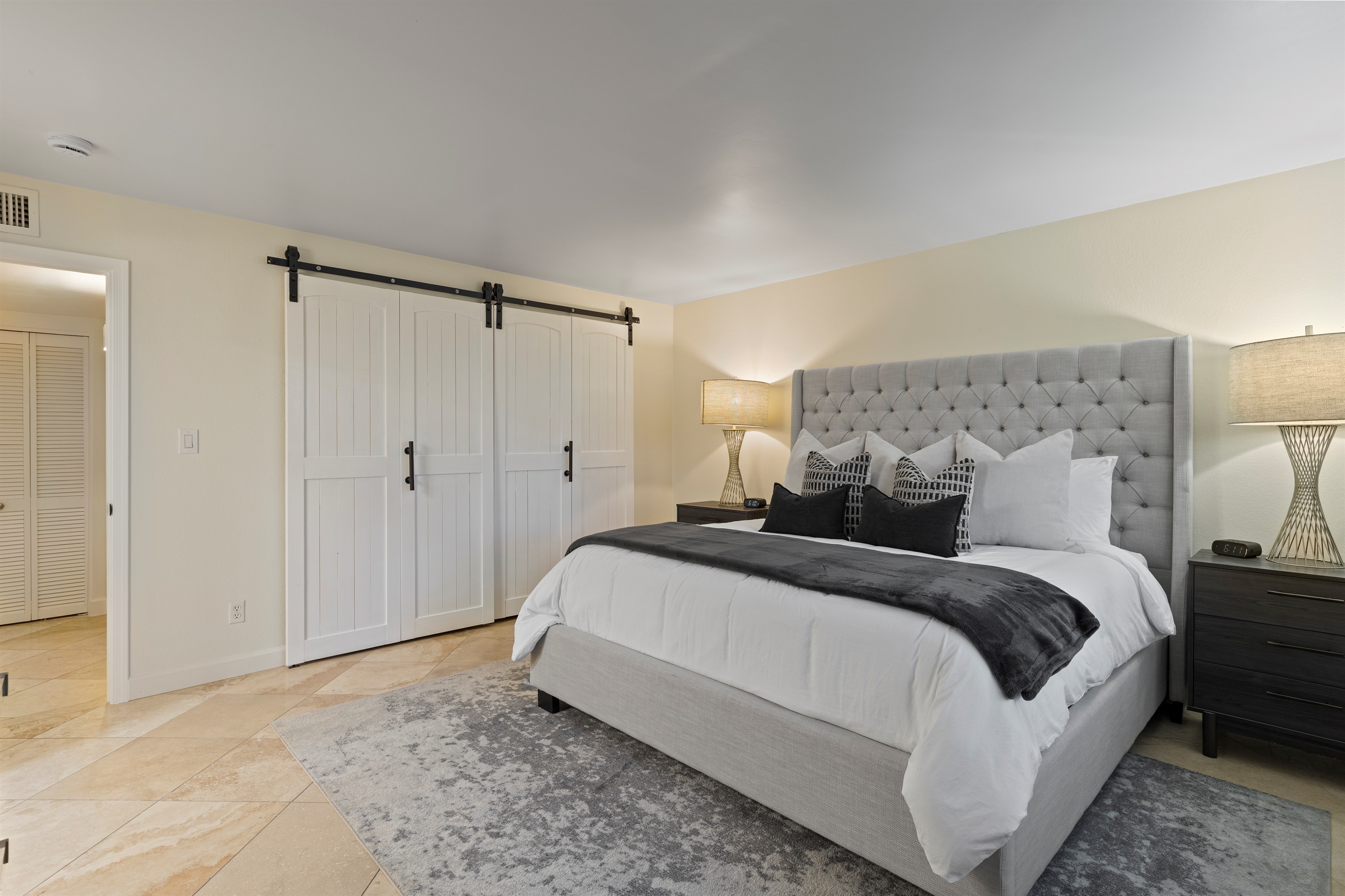 Primary bedroom featuring a king bed and direct access to the ensuite bathroom