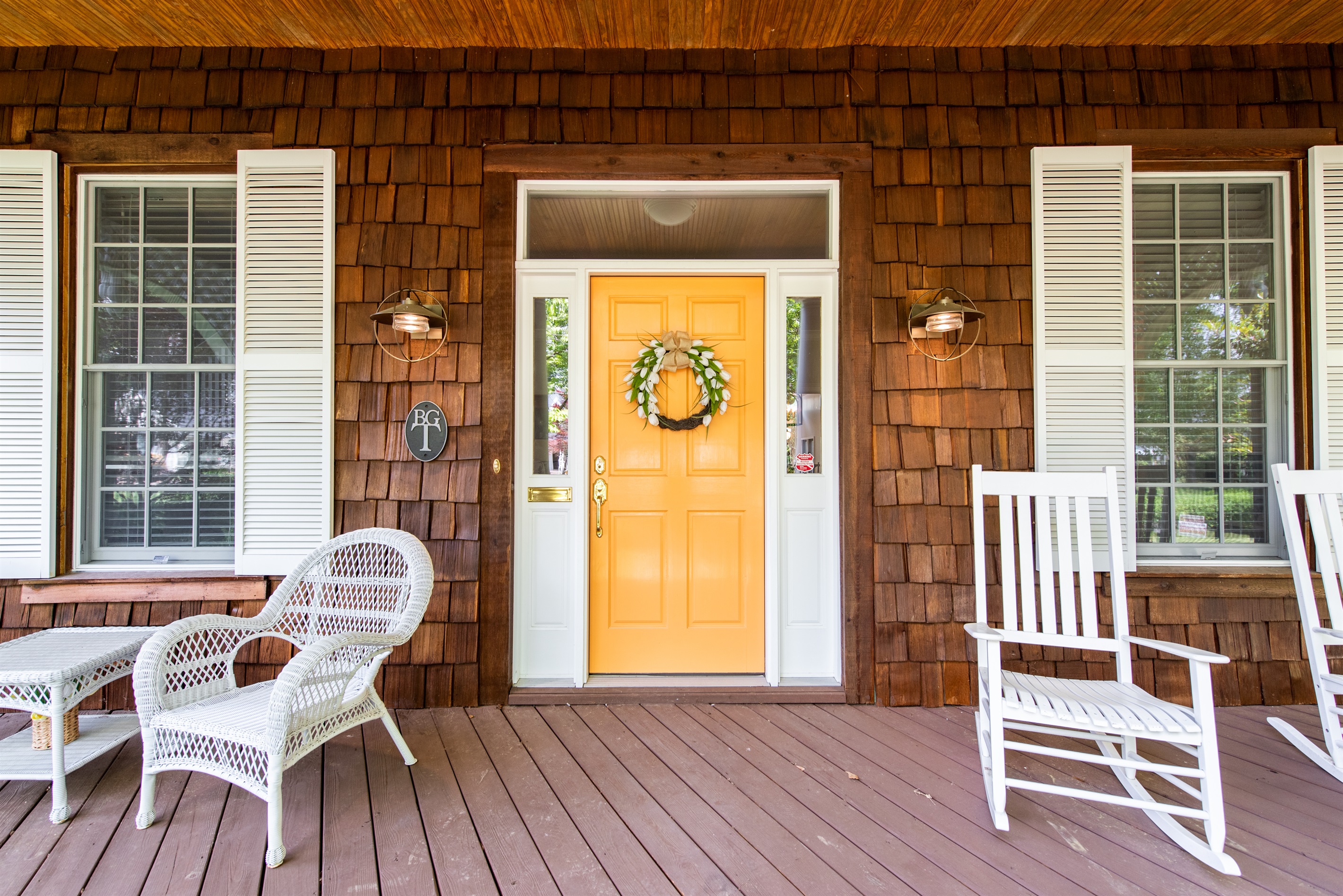 Charming front porch seating, ideal for sipping coffee and enjoying fresh air.