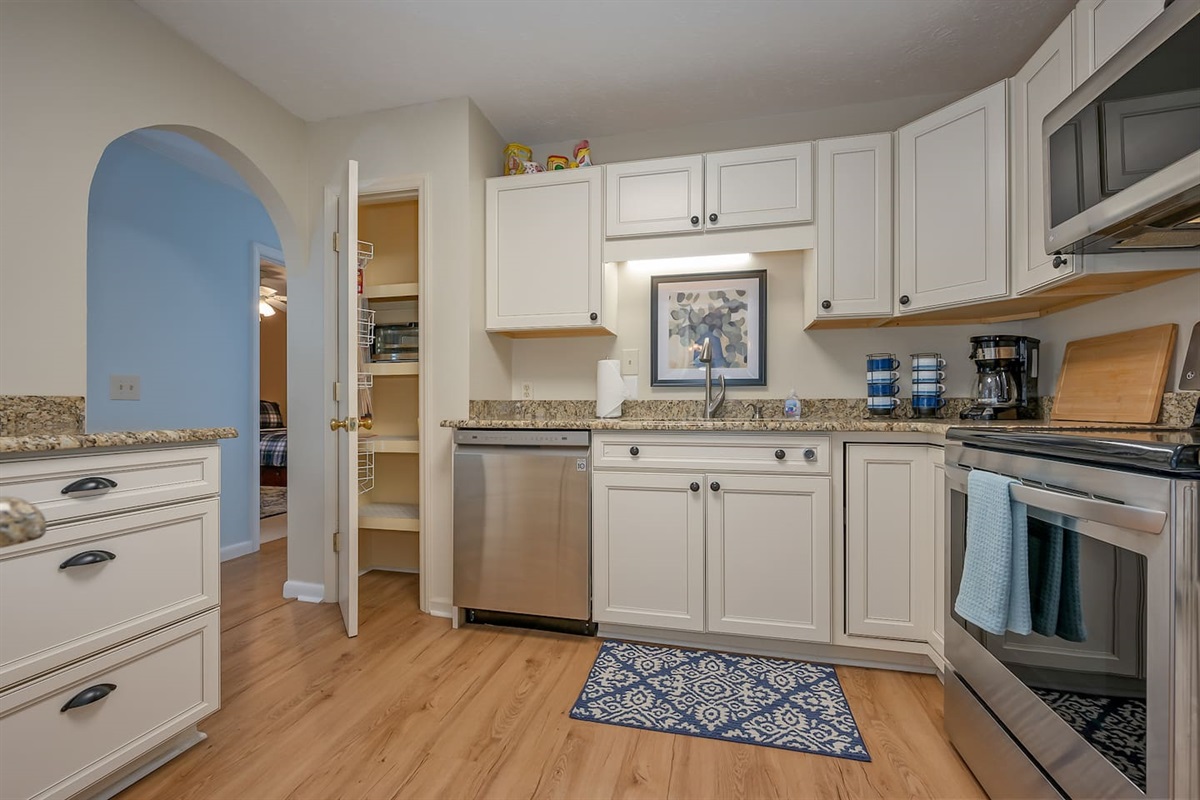 Updated kitchen with stainless steel appliances and countertops 