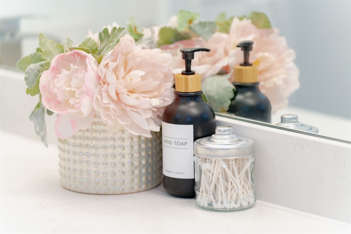 Guest bathroom with decorative shelving and chic accents.