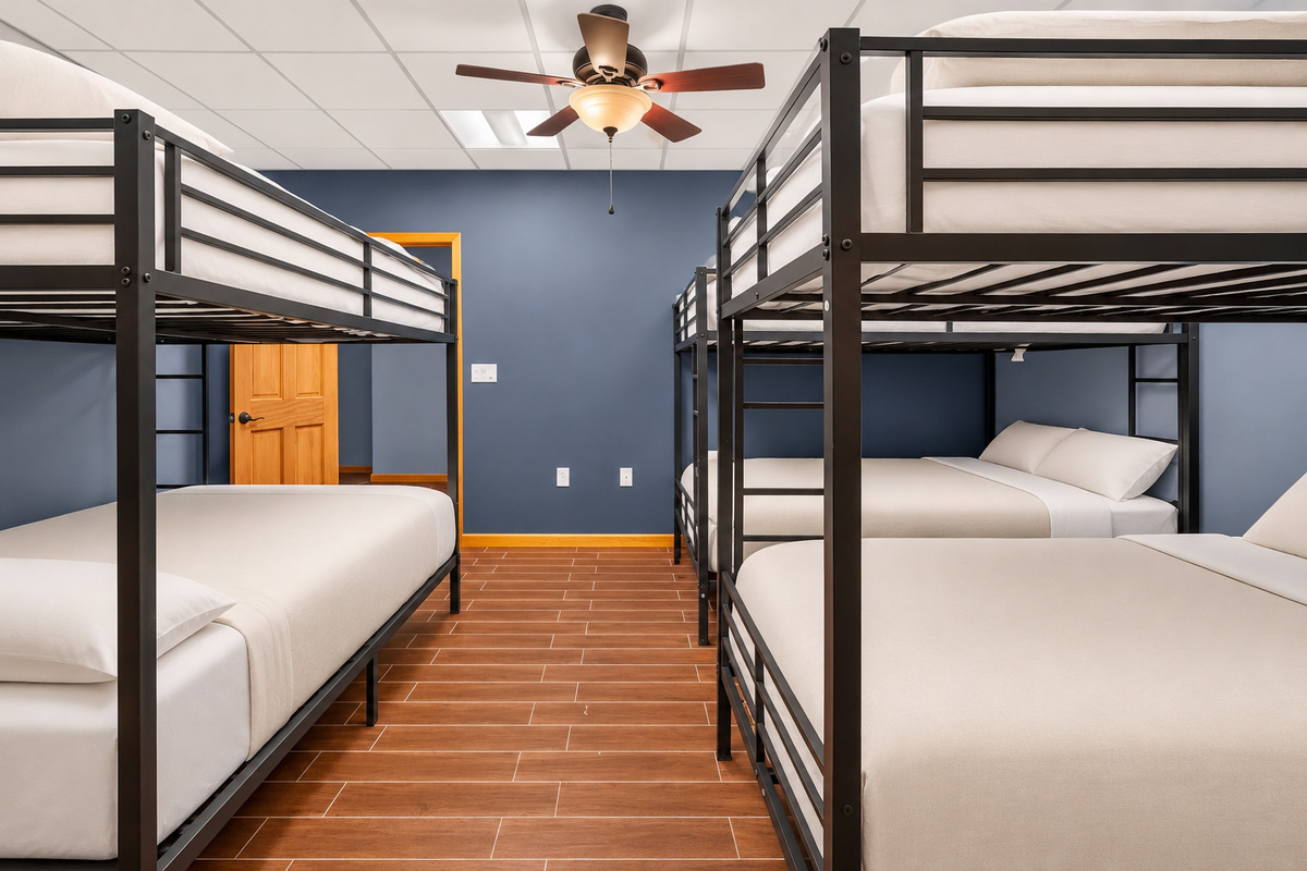 Spacious bunk room with white bedding