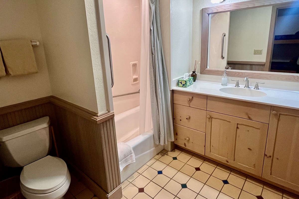 Bunk room bathroom with tub shower