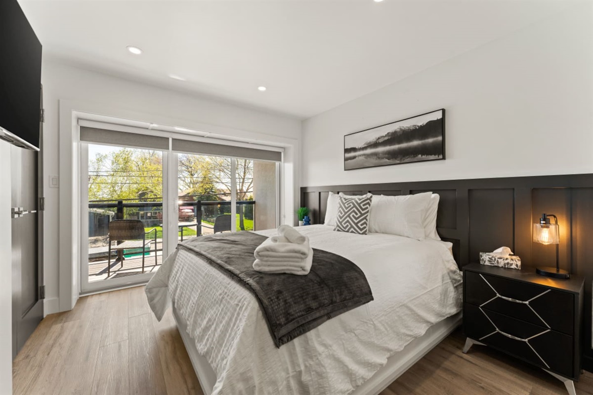 Queen Bedroom with private balcony and modern minimalist design.