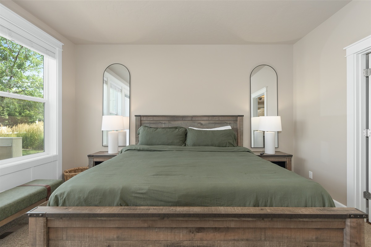Peaceful primary suite with soft, inviting bedding.