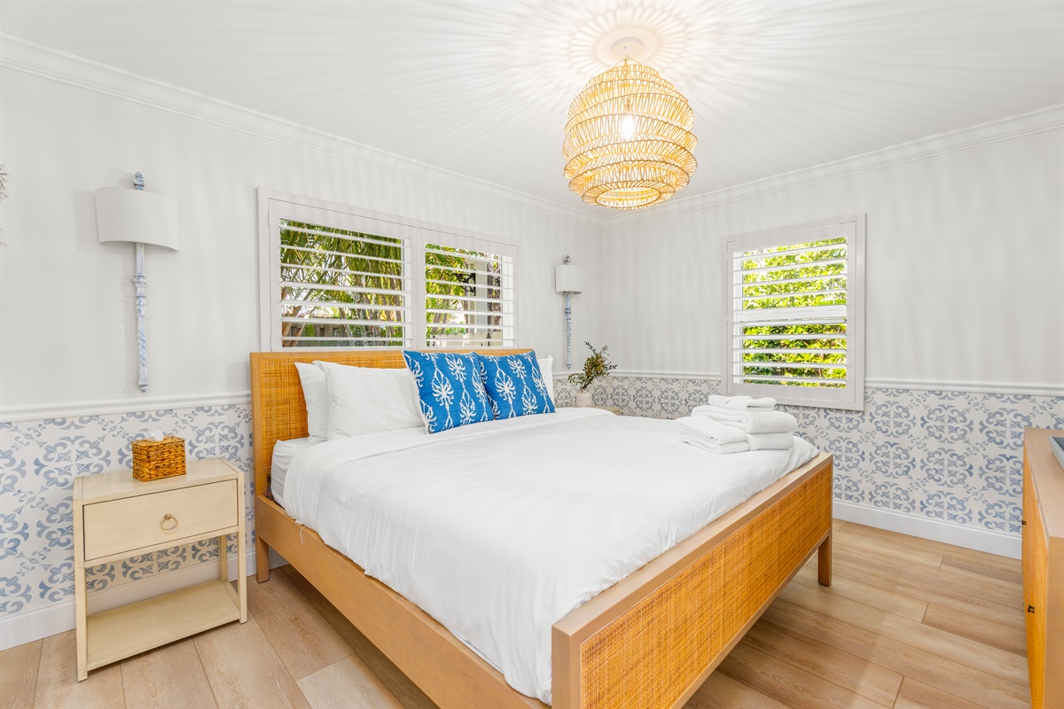 A light and welcoming bedroom styled with natural textures and soft coastal accents for a calm, comfortable stay.