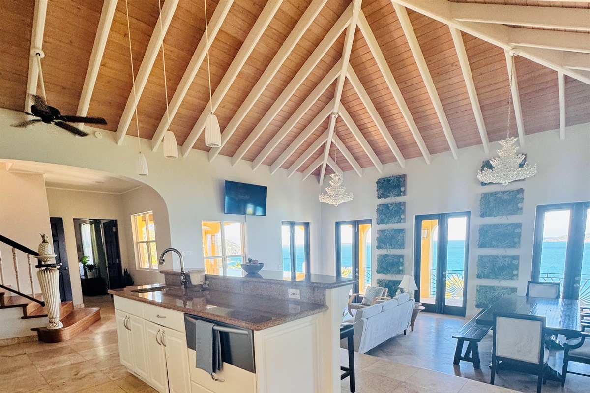 Stunning open-concept great room with vaulted ceilings, chef’s kitchen, and panoramic ocean views.