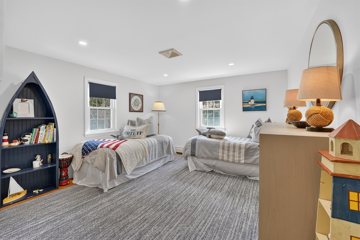 Relax in the welcoming fourth bedroom featuring two soft double beds!