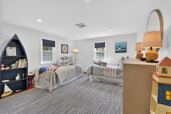 Relax in the welcoming fourth bedroom featuring two soft double beds!