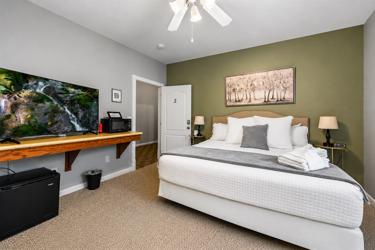 Rest and recharge in the plush king-sized bed, perfect for a peaceful night’s sleep.