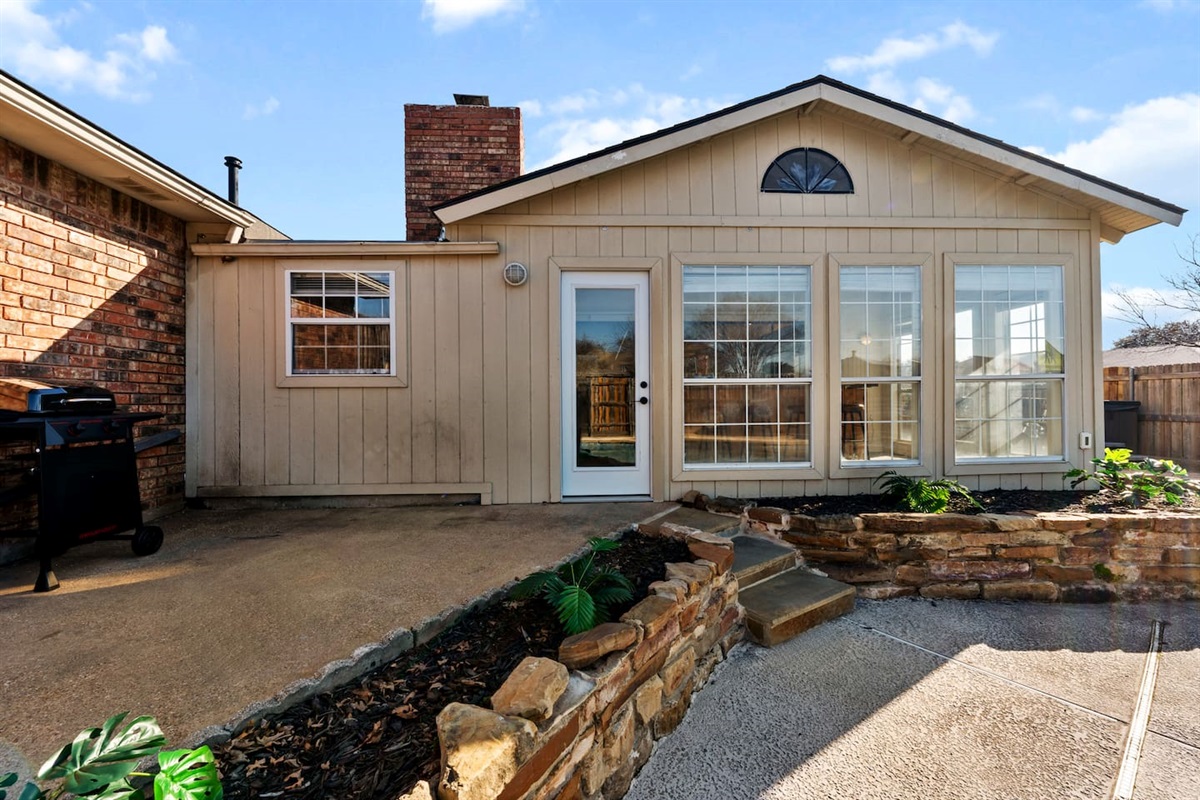 Grill up your favorites on the backyard BBQ just steps from the sunroom—perfect for outdoor dining and entertaining under the Texas sun.