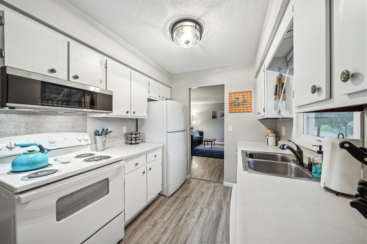 The upstairs galley kitchen connects the living room and dining area.