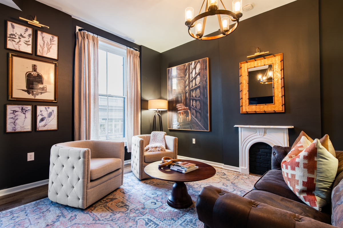 Living-room seating beside the tall windows.