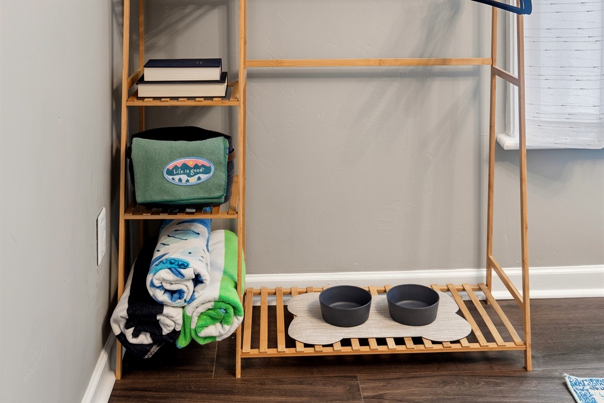 Dining area with storage shelf, board games, and beach gear available for guests