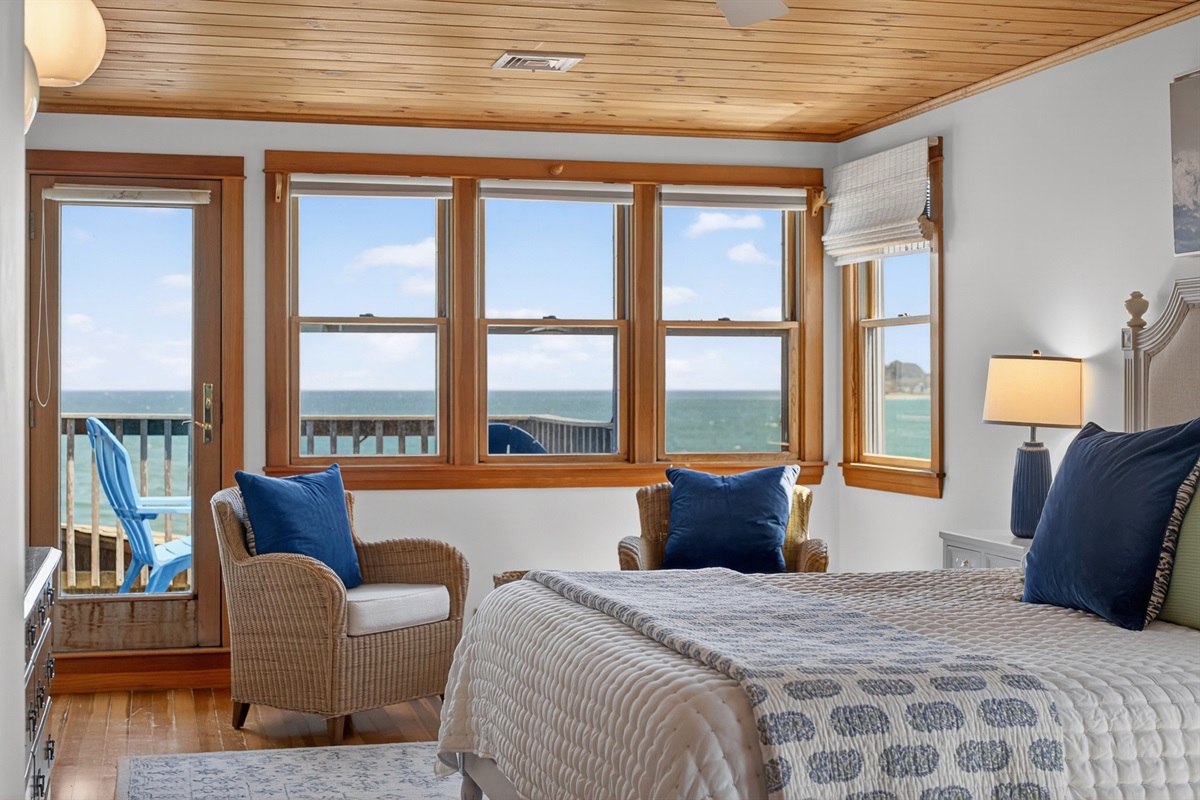 Bright coastal first bedroom with stunning ocean views and private deck access, your perfect seaside retreat. 🌊