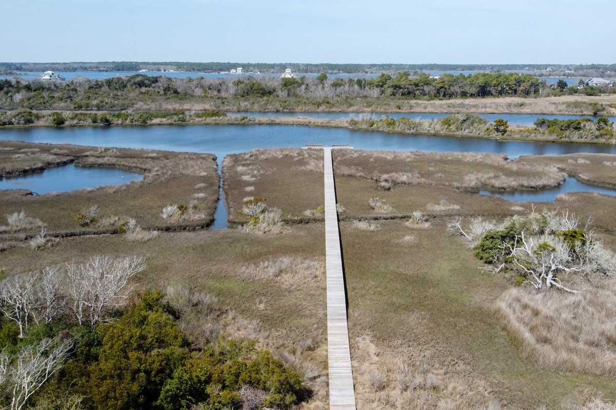 Private boardwalk leading through the marsh to the sound