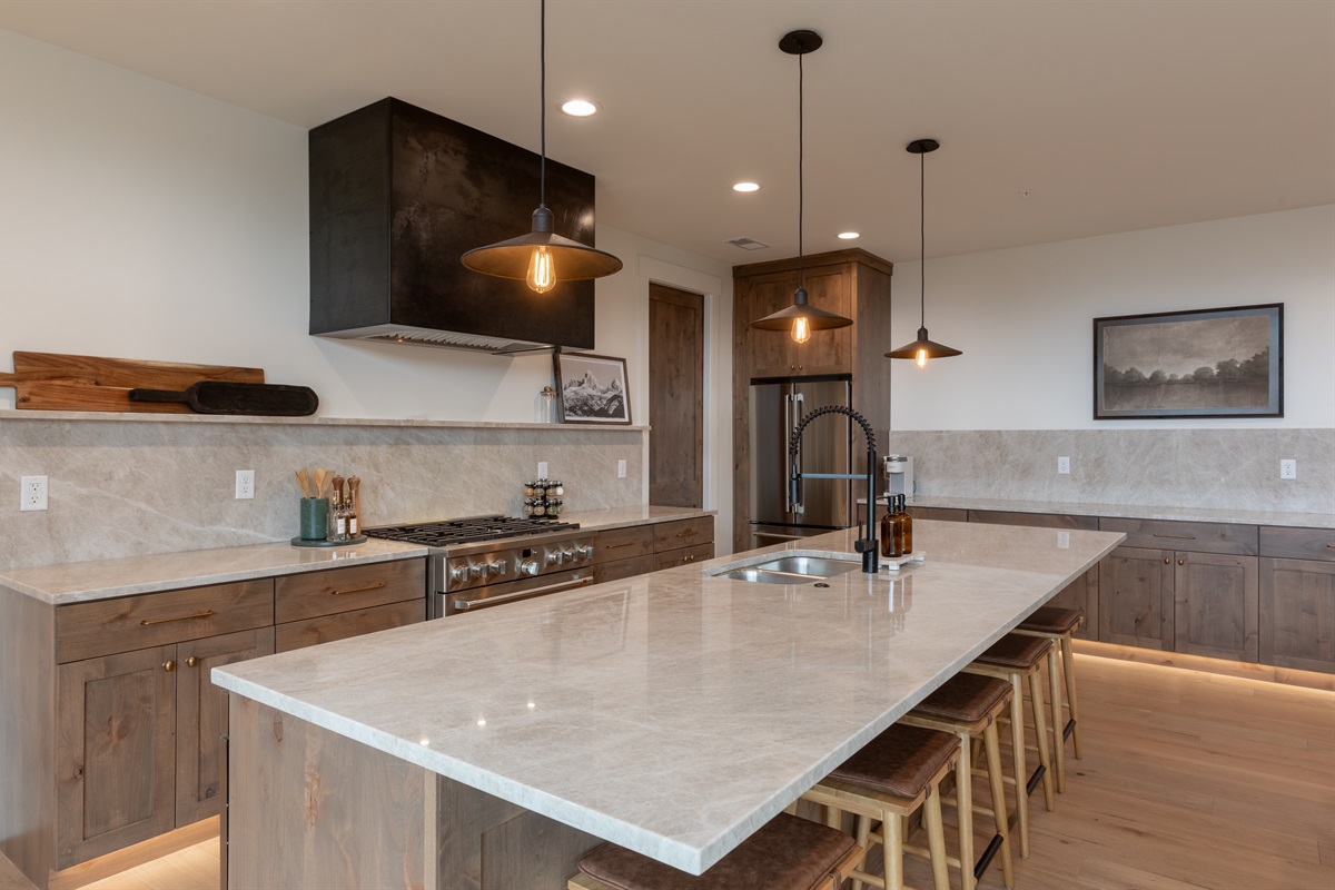 Middle Teton - Chef’s kitchen featuring high-end appliances, quartz countertops, and ample seating.