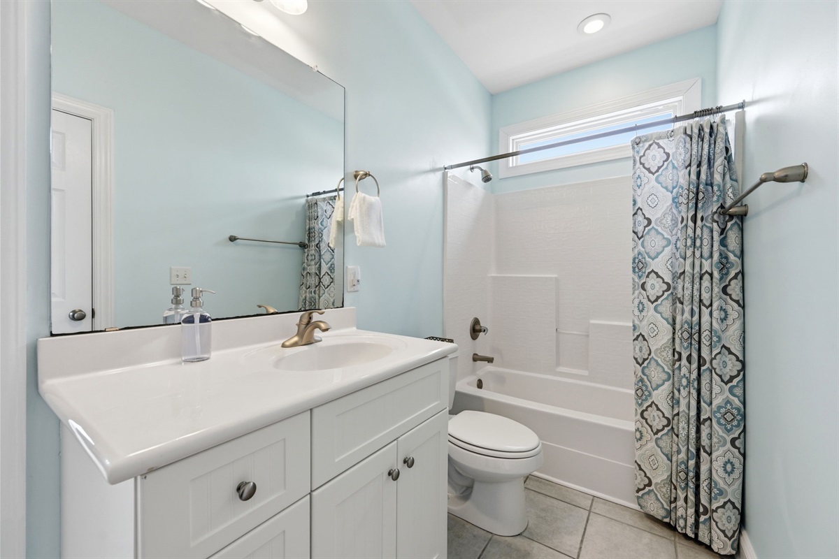 2nd floor bathroom with tub/shower combo and bright natural light
