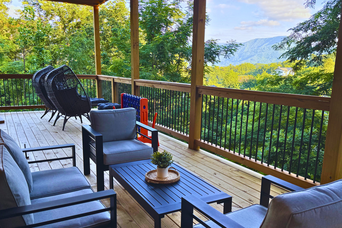 Your front-row seat to the Smokies. Unwind on the spacious covered lower deck with comfortable seating, mountain views, and plenty of room to enjoy your morning coffee or evening conversation.
