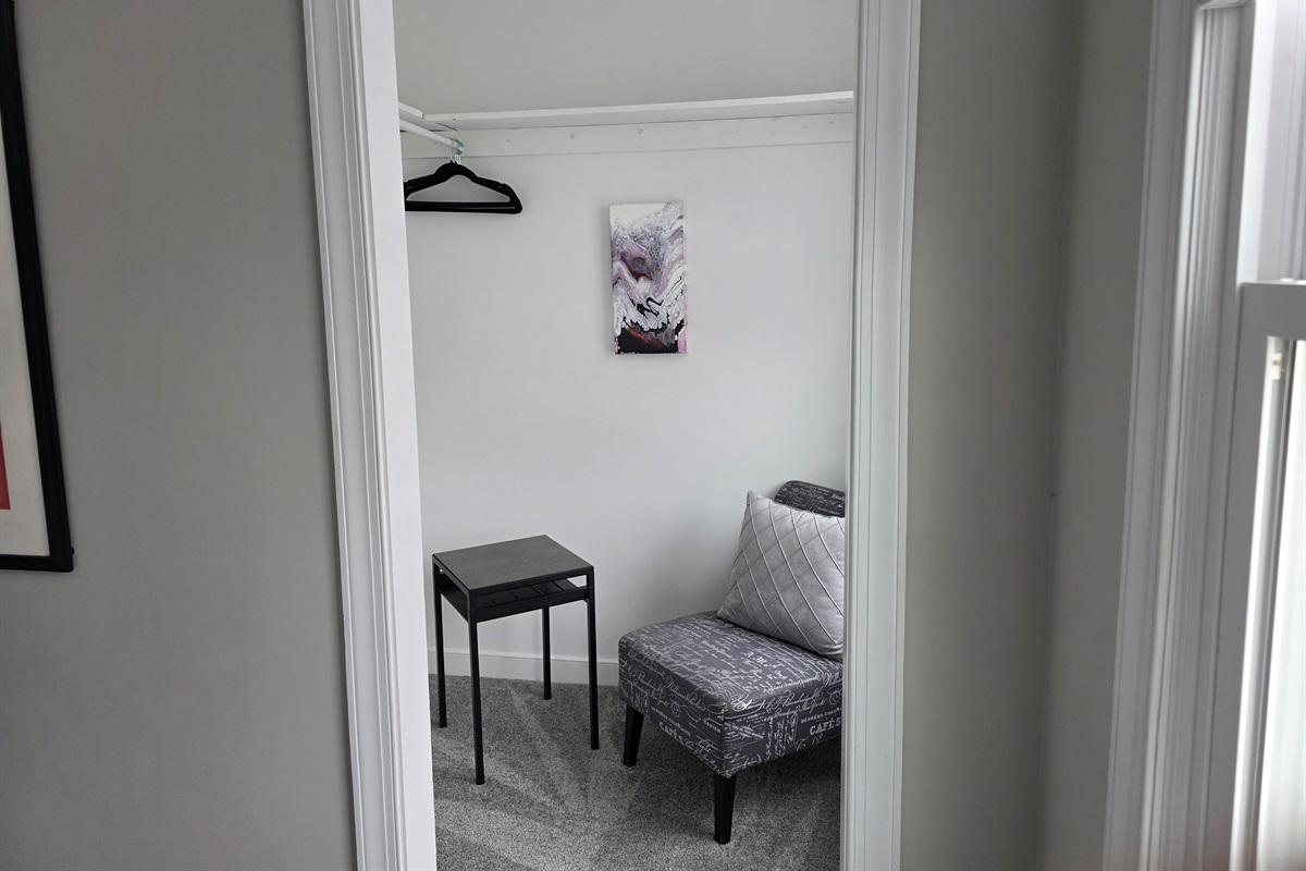 Cozy Reading Nook & Dressing Area in Bedroom 3: Functional dressing corner with a stylish accent chair and extra hanging space.