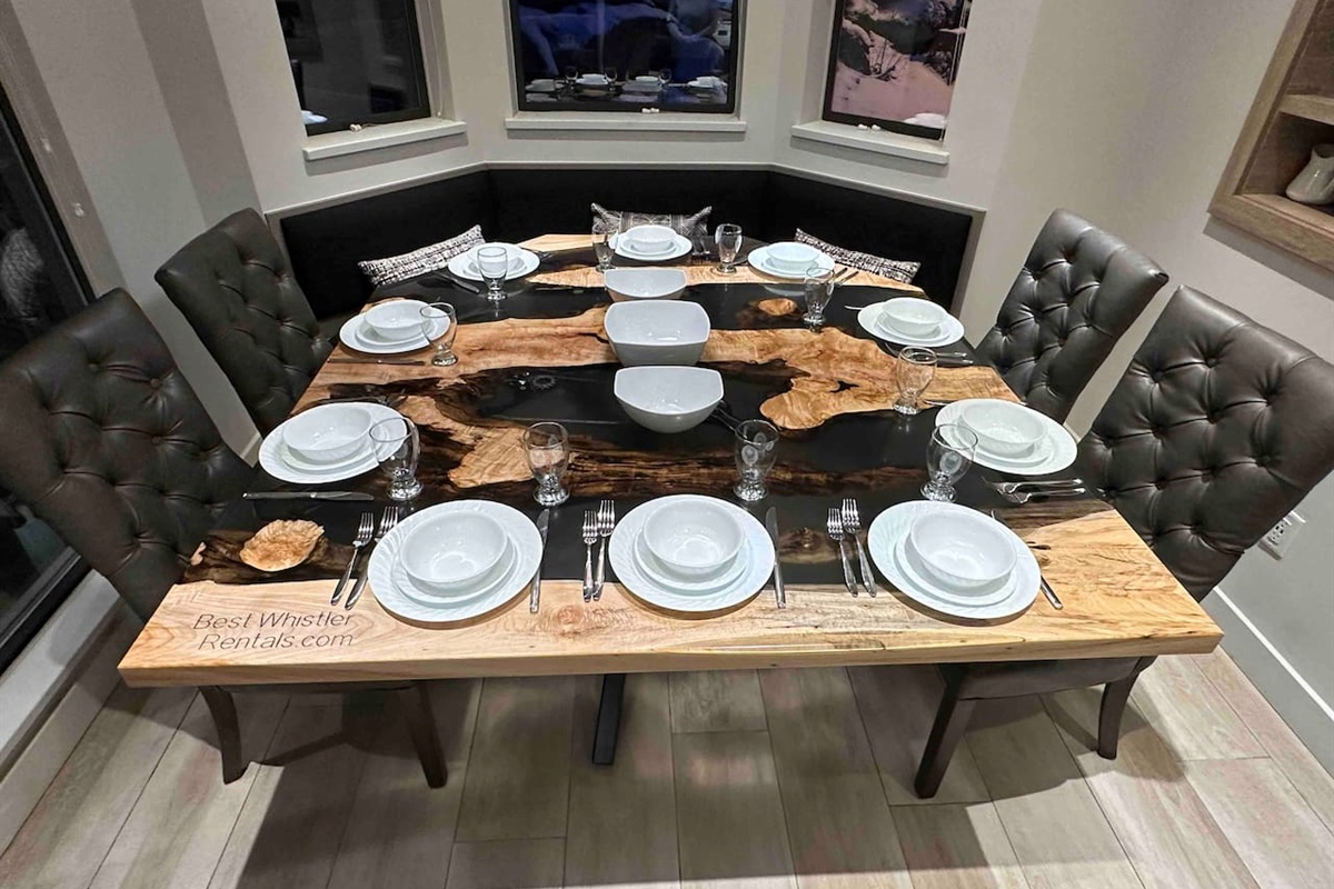 Extra large maple wood table was custom built in 2024. This unique live edge table offers more than enough room to comfortably seat 10 people. Dinnerware for 10ppl. Windows on 2 sides brings Whistler Blackcomb nature views  right into your kitchen 