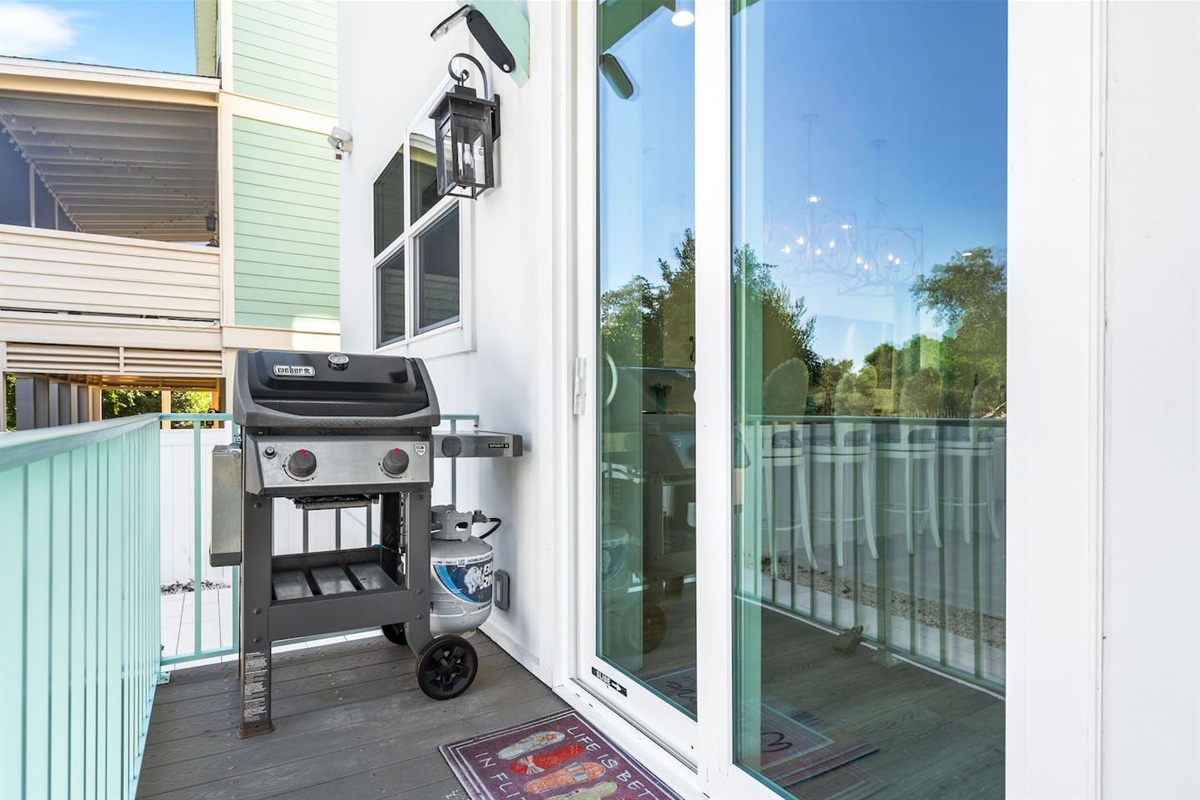 Fenced backyard oasis! Slide open the glass doors to a Weber BBQ grill, perfect for alfresco dining. Choose to eat at the outdoor table, on the breezy upper deck, or stay cool inside. The ultimate private setup for your next summer cookout.