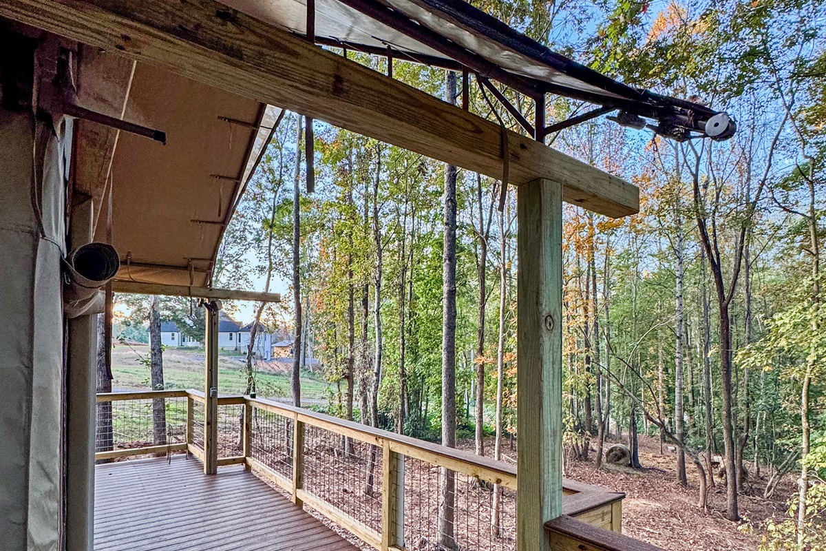 Deck: Enjoy morning coffee with stunning woodland views and fresh air in Troutman!