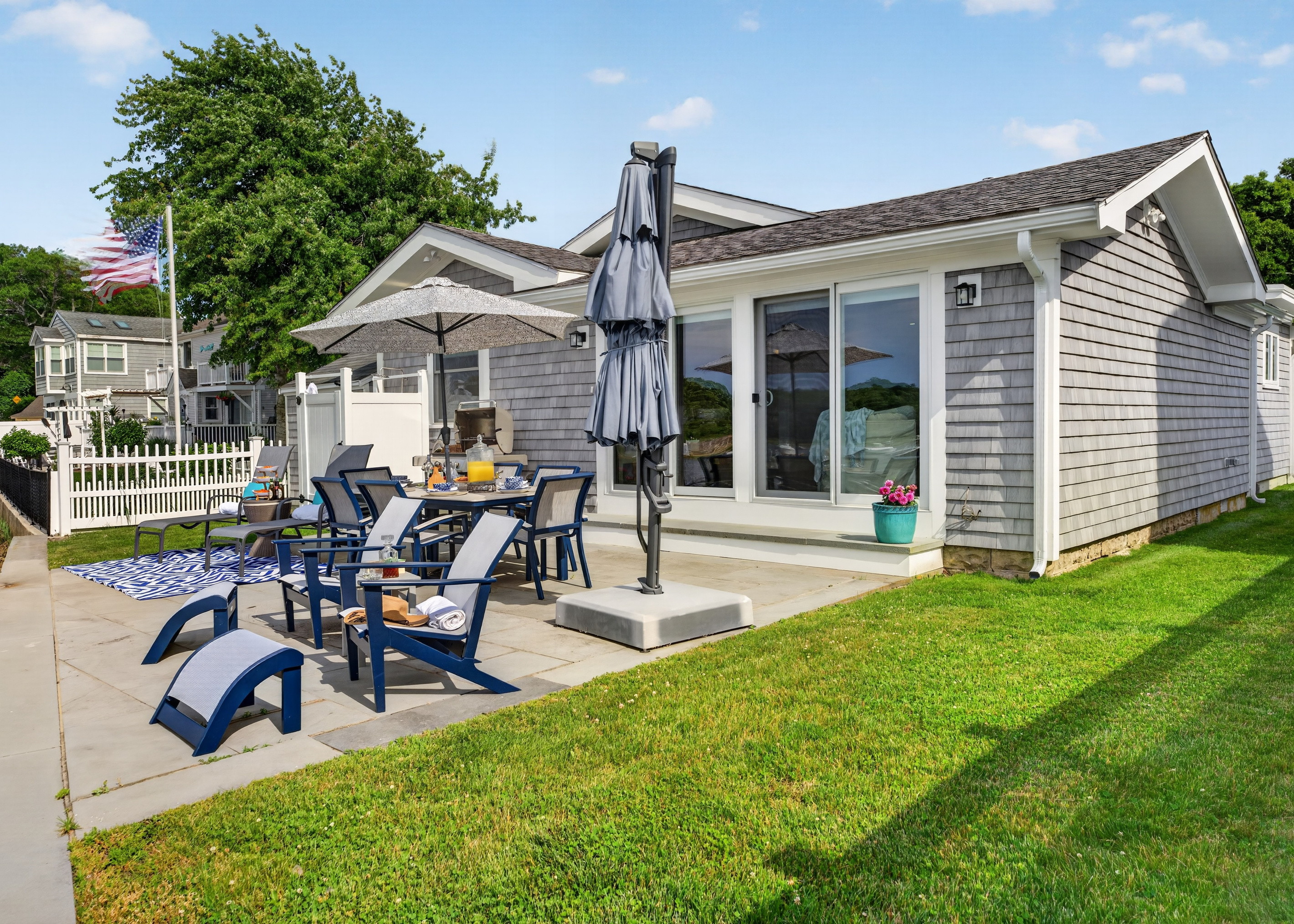Relax in the backyard with comfortable Adirondack chairs and inviting outdoor seating.