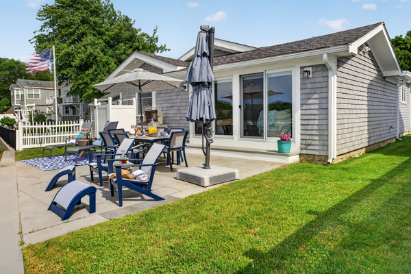 Relax in the backyard with comfortable Adirondack chairs and inviting outdoor seating.