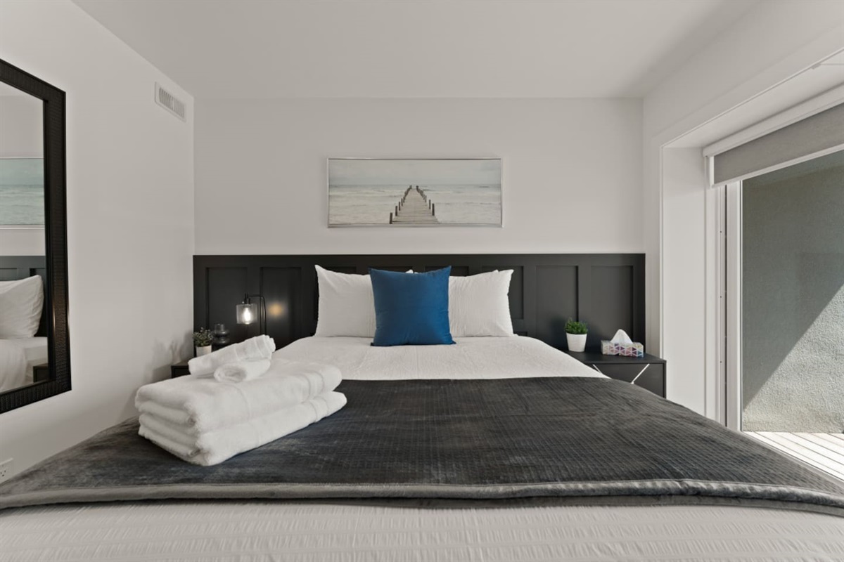 Natural light floods this west facing bedroom. Perfect for admiring sunsets on the private balcony.