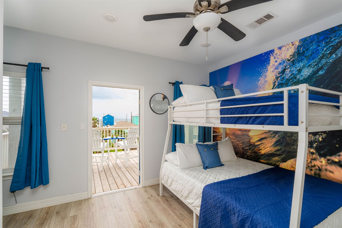 Wave Room upstairs — full-over-queen bunk, 43" TV, Mortal Kombat arcade *in the room*. Kids' dream setup.