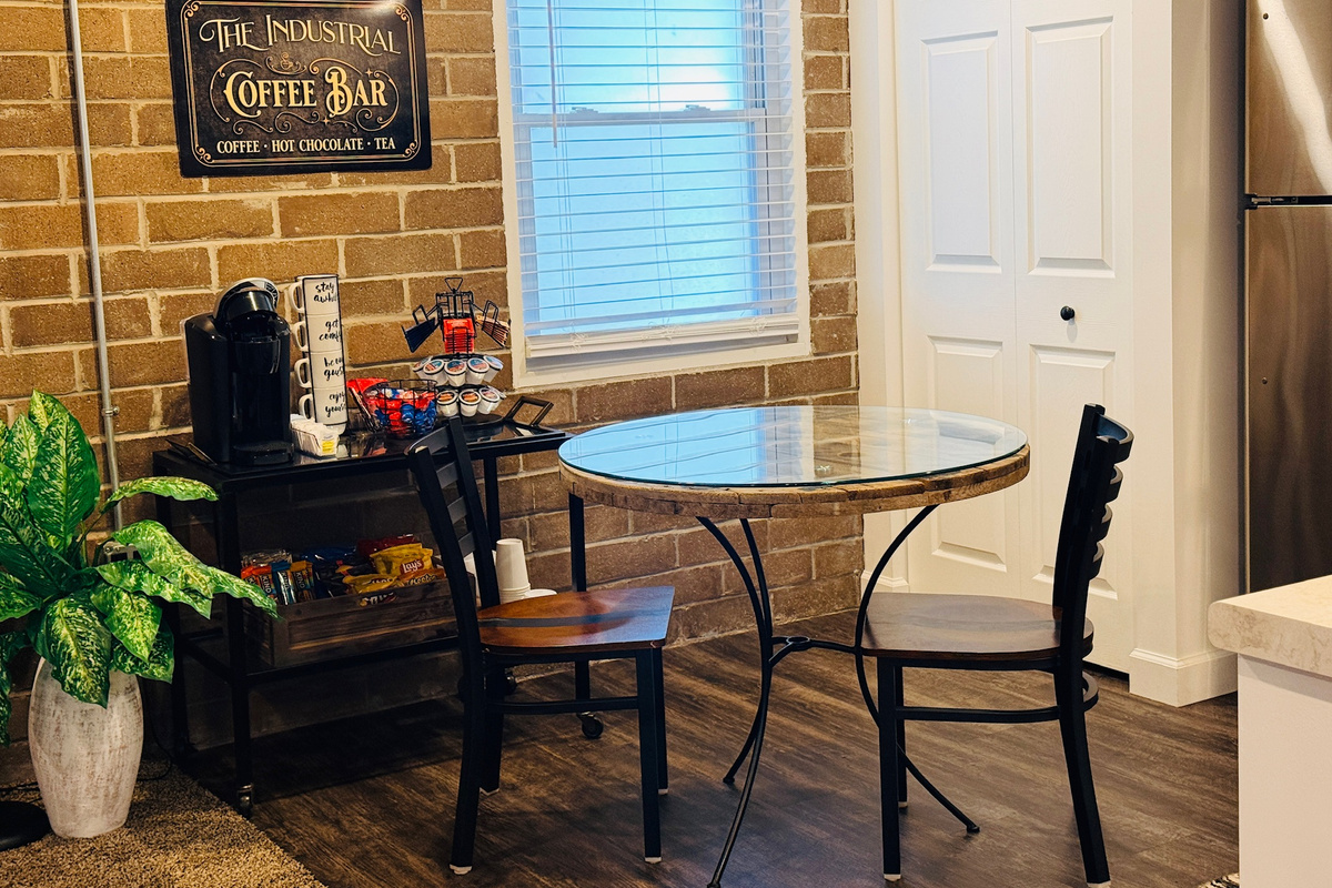 Dining table and stocked coffee bar create a convenient spot for meals and morning coffee.