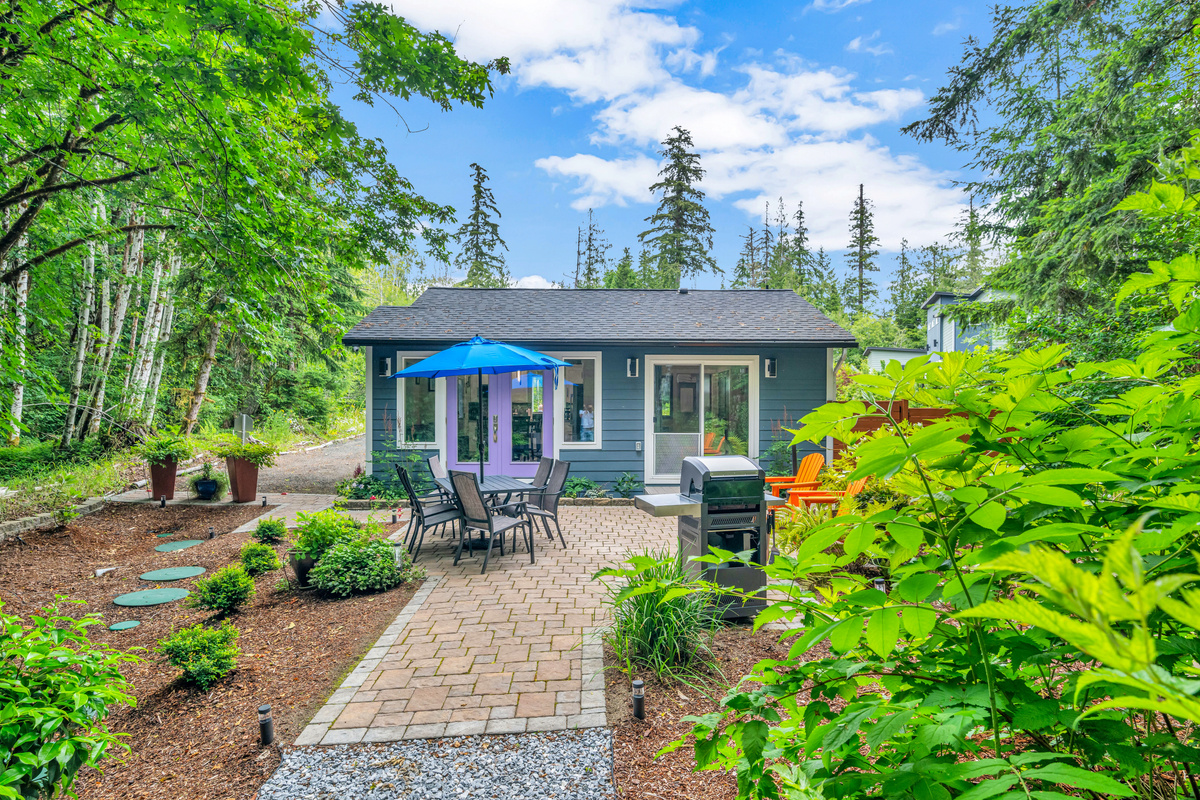 650 sq ft patio with Adirondack chairs, dining table for 6, and stainless steel commercial infrared grill for summer cookouts.