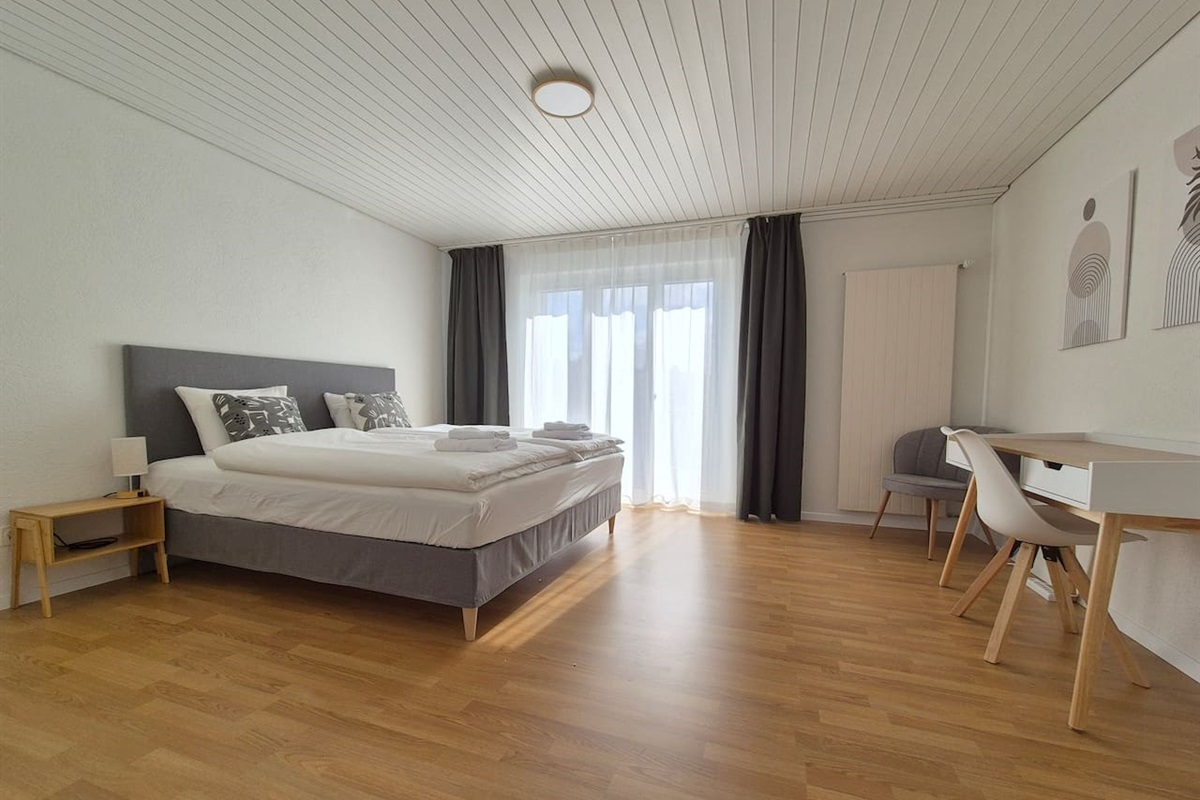 Bedroom 1: King sized boxspring bed (180x200cm) with desk, wardrobe / closet and a private balcony