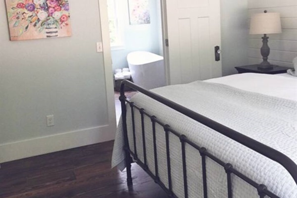 Downstairs King Bedroom and oversized romantic tub in cottage